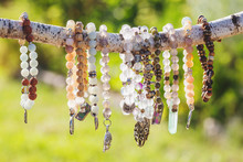 Collection Of Mineral Stone Beaded Bracelets On Natural Outdoor Background