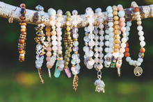 Collection Of Mineral Stone Beaded Bracelets On Natural Outdoor Background