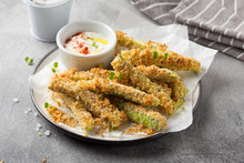 Zucchini Sticks In Breadcrumbs, With Cheese, Herbs, Breadcrumbs And White Yogurt Sauce. Healthy Snack, Summer Food