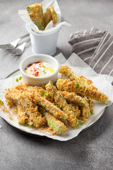 Canvas Print - Zucchini sticks in breadcrumbs, with cheese, herbs, breadcrumbs and white yogurt sauce. Healthy snack, summer food