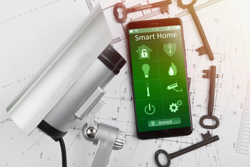 Wall Mural - Home security concept smartphone with smart home app and surveillance cctv camera on the desk