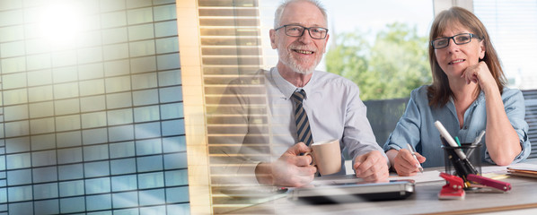 Wall Mural - Portrait of two business people working together; multiple expos