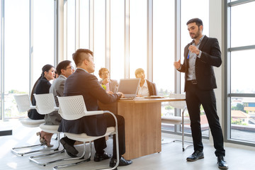 Businesspeople discussing together in conference room during meeting at office.