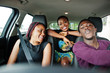 Young african american friends sitting inside a car.