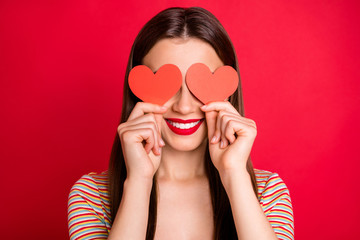 Wall Mural - Close-up studio photo portrait of pretty charming lady with toothy beaming smile holding two small paper cards in hands isolated bright background