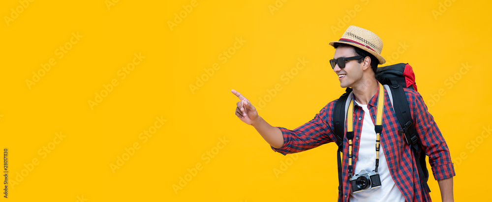 Young Asian tourist pointing to empty space - obrazy, fototapety, plakaty 
