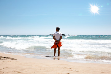 Sticker - A lifeguard boy on the beach in a summer sunny day