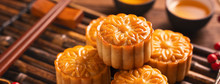 Moon Cake Mooncake Table Setting - Round Shaped Chinese Traditional Pastry With Tea Cups On Wooden Background, Mid-Autumn Festival Concept, Close Up.