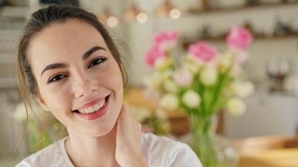 Poster - Close up view of smart smiling young brunette woman looking at the camera