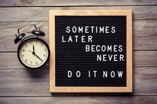 Wall Mural -  - Inspirational motivational quote Sometimes later becomes never. Do it now words on a letter board on wooden background near vintage alarm clock. Success and motivation concept.