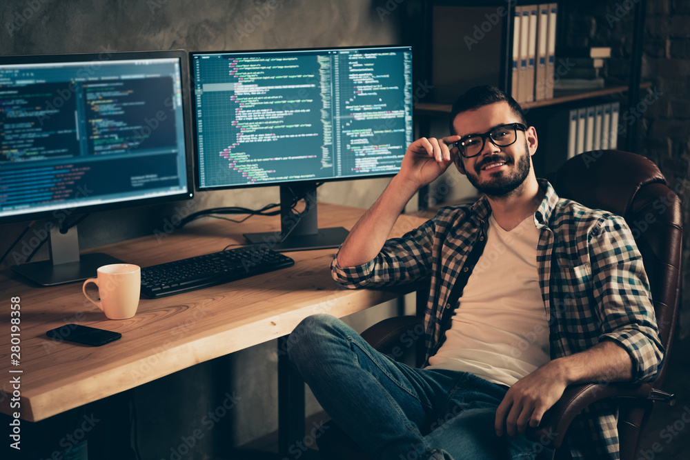 Portrait of nice attractive confident content cheerful bearded guy wearing checked shirt professional expert specialist shark genius at wooden industrial interior work place station indoors