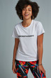 Three-quarter front view shot of dark-skinned girl with afro hairstyle, wearing white T-shirt with print 