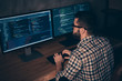 © deagreez - Close up back rear behind photo handsome he him his guy typing writing keyboard development outsource IT processing language two monitors table office wear specs formalwear plaid shirt