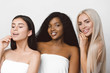 © Tetiana Moish - concept of three different ethnicity of women being very close one to each other and posing naked covered with cloth and expressing friendship. Young women with natural make-up and hair style.