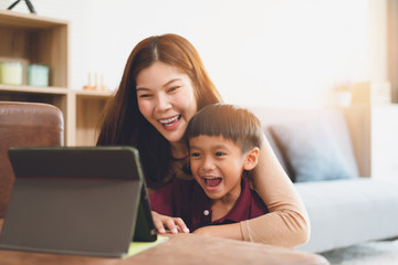 Wall Mural - image of happy family at living room,happiness time of family playing at home,Mom and baby are happiness coexistence,happy family concept and Creating activities to strengthen skills for children.