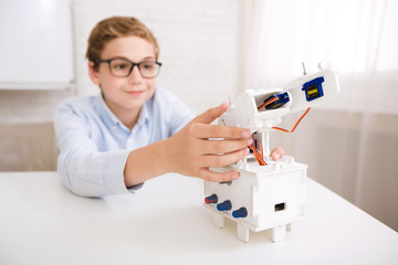 Poster - Smart boy testing his robotic device on engineering classes