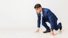 Business Man Kneeling Ready To Run On White Background