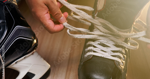 Pro Ice hockey, He shoe stringer in the athlete's dressing room Canvas Print