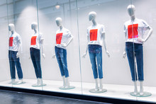 Mannequins On A Shop Window In A Shopping Center In Mocap Undershirts And Jeans. Sell-out.