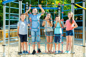 Wall Mural - Five  kids posing  at the playground together