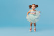 © oes - Little happy toddler child girl dreams of becoming ballerina in a cyan tutu skirt. Blue background. Space for text