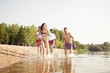 © opolja - Group of happy friends running in to water - active people having fun on the beach on vacation