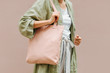 Woman holding canvas tote bag. Reusable eco bag. Eco friendly concept.