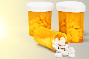 Canvas Print - Medication pills in pills bottles on background