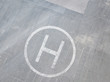 helicopter helipad on the asphalt surface with letter 