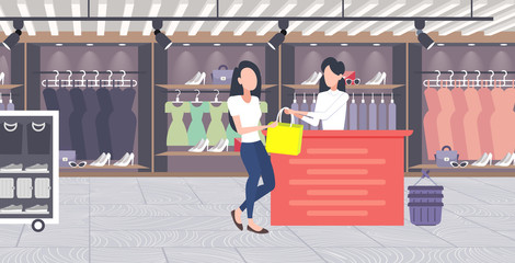 Wall Mural - woman customer buying new handbag at cash desk counter fashion shop cloth store female shopping mall modern boutique interior flat horizontal