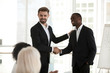© fizkes - Excited businessman shake hand African American employee at meeting