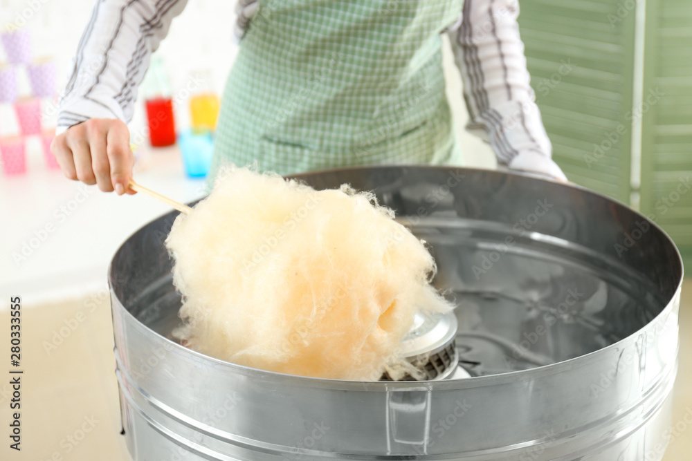 Woman making cotton candy at fair