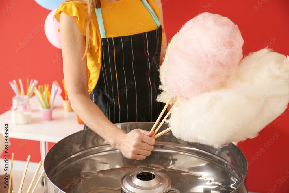 Woman making cotton candy at fair