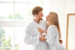 © Pixel-Shot - Morning of happy young couple in bathrobes at home