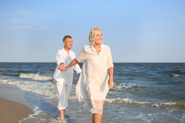 Sticker - Happy mature couple at sea resort