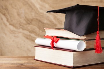 Canvas Print - Graduation hat and stacks of books