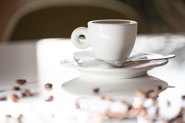 A cup of coffee on a white table in a coffee house