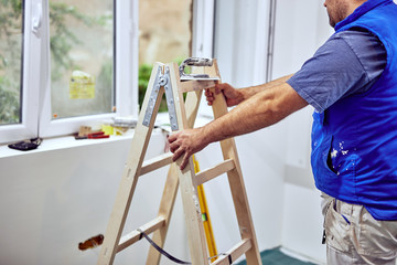 Wall Mural - Worker inside the house - renovation fixes.