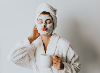 Beautiful Luxury Life. Breakfast. Happy Girl with a Cup of Coffee. Home Style Relaxation Woman Wearing Bathrobe and Towel after Shower. Spa Good Morning.Cosmetic procedure. Beauty spa and cosmetology.