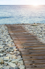 Wooden Path To The Pebble Beach.