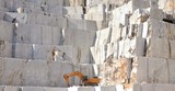 Fototapeta  - Marble quarry with a Excavator loader, open mining, Italy