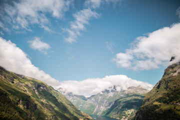 Wall Mural - view of mountains with clouds in geiranger