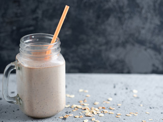 Wall Mural - Chocolate milk smoothie with oatmeal nuts and cinnamon. Healthy breakfast
