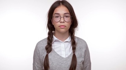 Poster - Upset young brunette girl student shaking head and becoming disappointed while looking at the camera over white background isolated