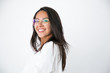 © Mangostar - Happy cheerful professional posing in studio. Beautiful young Latin woman in white shirt and stylish eyeglasses smiling at camera. Female portrait concept