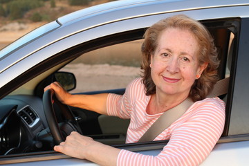 Cute mature female driver smiling