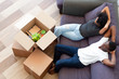 Above view african couple resting on couch on moving day