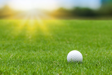 Sticker - Golf ball on green grass on blurred beautiful landscape of golf course with sunrise,sunset time on background.