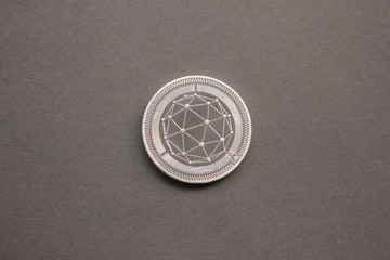 Wall Mural - Qtum on gray background. Flat lay, top view perspective