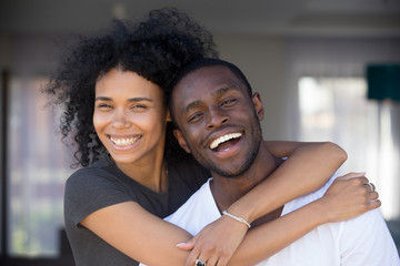 Headshot portrait happy african couple in love hugging outdoors